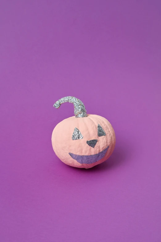 a pumpkin sitting on top of a purple surface, glitter sticker, looking towards camera, without text, pink and orange