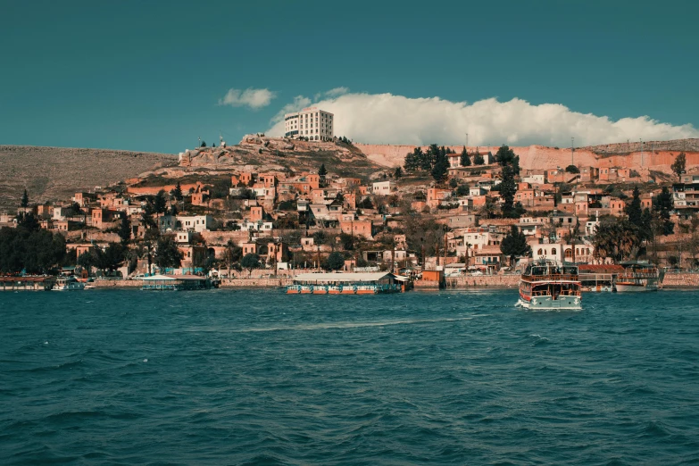 a boat in the middle of a body of water, a tilt shift photo, pexels contest winner, renaissance, city on a hillside, jordan, viewed from the ocean, 2 0 2 2 photo