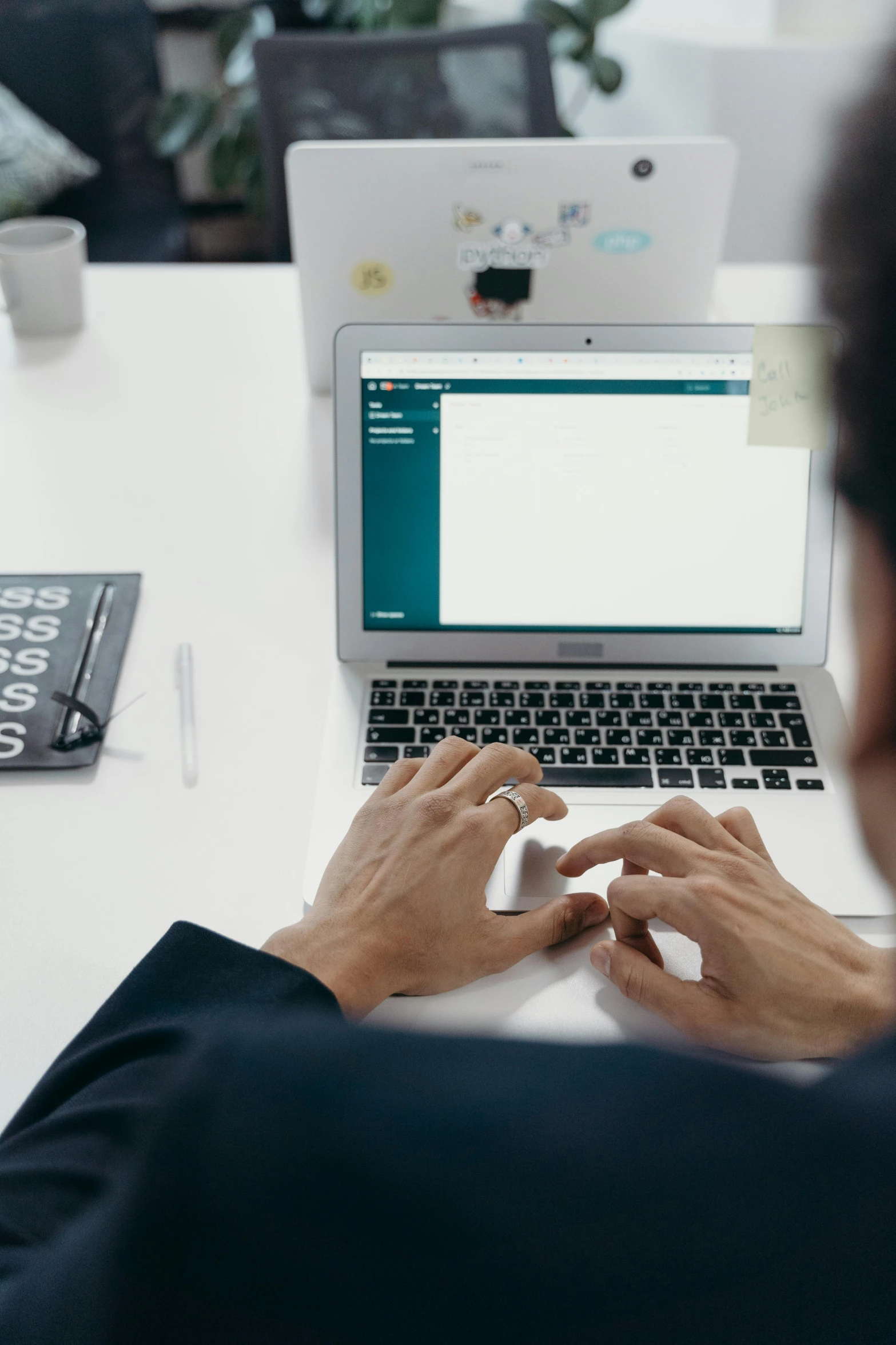 a man sitting in front of a laptop computer, by Sebastian Vrancx, trending on unsplash, on a white table, tech demo, official screenshot, programming