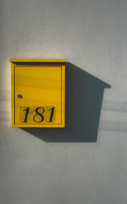 a yellow mail box sitting on the side of a wall, by Sebastian Spreng, sign that says 1 0 0, high quality photo, 1 2 9 7, small