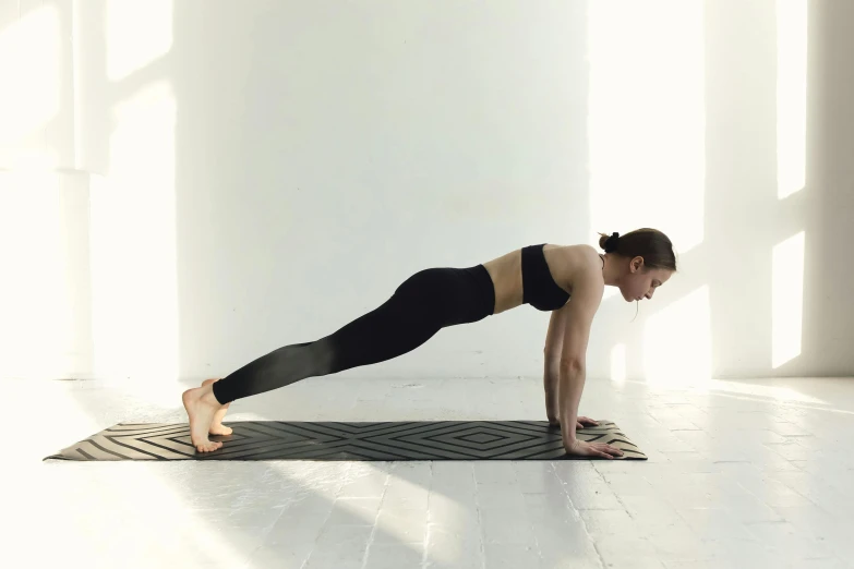 a woman is doing a yoga pose on a mat, pexels contest winner, arabesque, smooth porcelain skin, profile image, 6 pack, 🦩🪐🐞👩🏻🦳