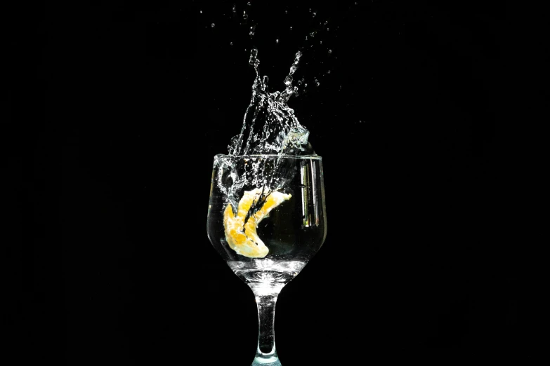 a glass of water with a lemon in it, by Jan Rustem, pexels, photorealism, leaping, high contrast, celebration, nightcap