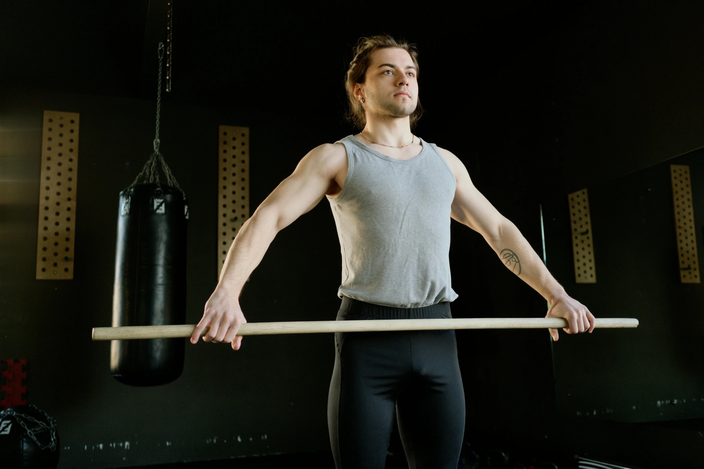 a man holding a pole in a gym, a portrait, pexels contest winner, renaissance, wearing a muscle tee shirt, avatar image, caucasian, barrel chested