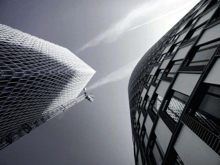 a couple of tall buildings next to each other, inspired by Zaha Hadid, pexels contest winner, minimalism, intricate image, chrome and carbon, “derelict architecture buildings, norman foster