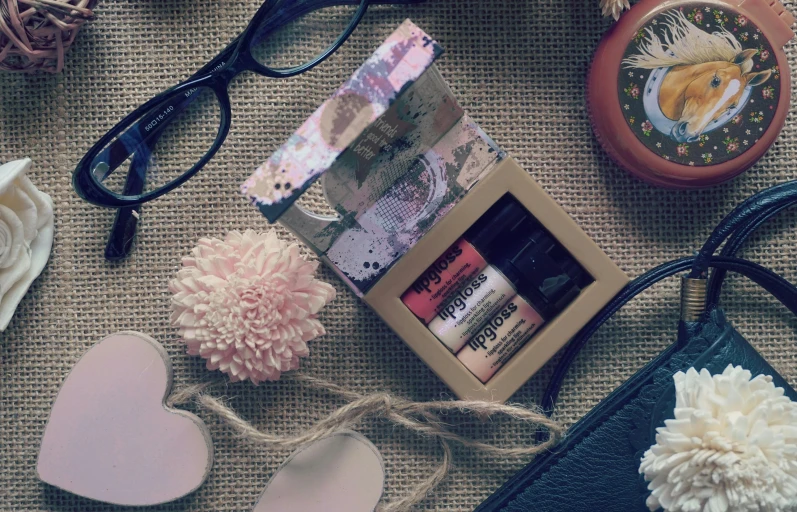 the contents of a purse are laid out on the floor, pexels contest winner, photorealism, brown and pink color scheme, inside its box, glasses, nail polish
