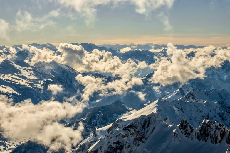 a view of snow covered mountains from an airplane, by Matthias Weischer, pexels contest winner, voluminous clouds, panorama, fine art print, chamonix