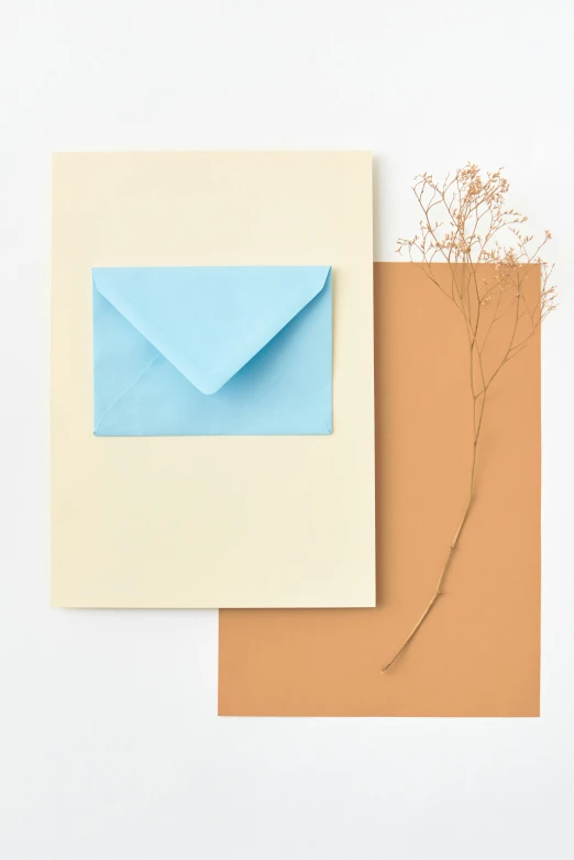 a couple of envelopes sitting on top of each other, a minimalist painting, by Harvey Quaytman, trending on unsplash, burnt sienna and cerulean blue, made of silk paper, greeting card, 1960s color photograph