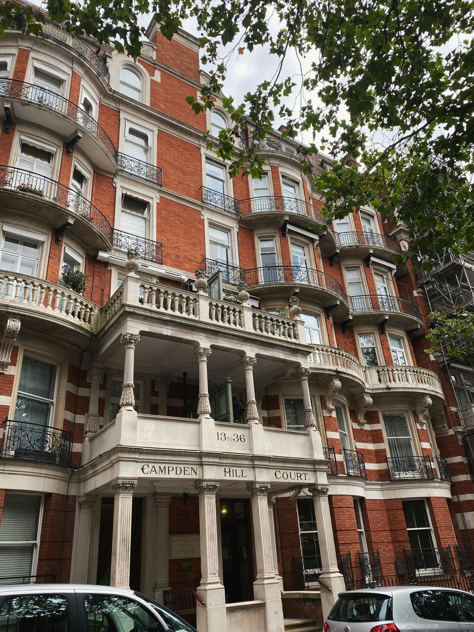 a building with cars parked in front of it, unsplash, art nouveau, 1 9 th century london, hotel room, low quality photo, thumbnail