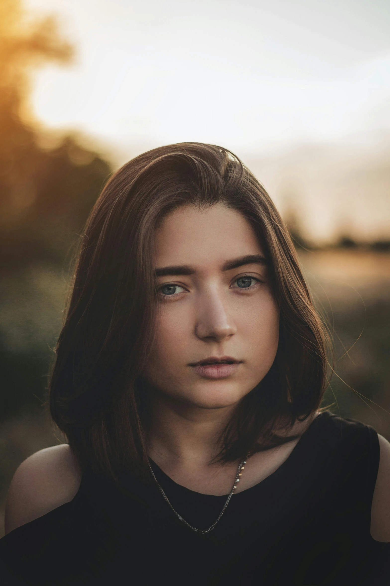 a beautiful young woman standing in a field, a character portrait, pexels contest winner, perfectly shaded face, hyperrealistic teen, front lit, mid - length hair