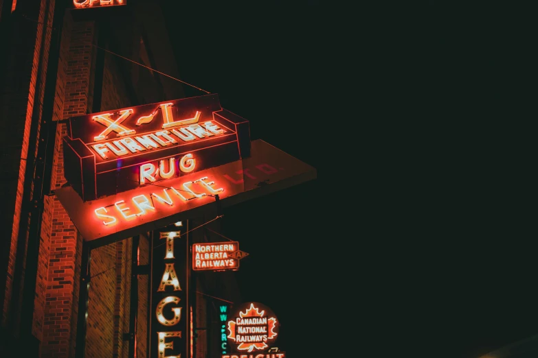 a couple of neon signs on the side of a building, a photo, by Nick Fudge, pexels contest winner, rugs, historical photo, night. by greg rutkowski, family photo