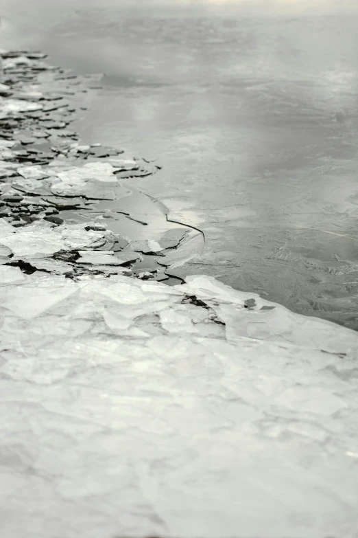 a black and white photo of a body of water, inspired by Vija Celmins, flickr, on the frozen danube, minn, close-up print of fractured, 1960s color photograph