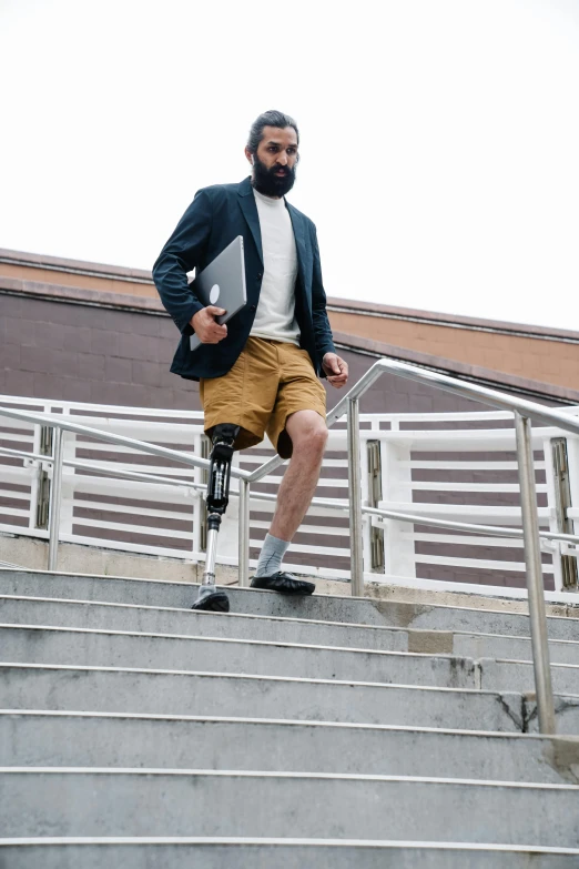 a man with a prosthetic leg walking up a flight of stairs, unsplash, full body image, ( ( theatrical ) ), prosthetic, catalog photo