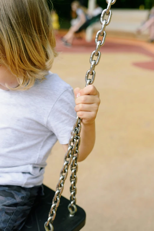 a little girl that is sitting on a swing, by David Simpson, pexels, intricate chrome chains, closeup of arms, teenage boy, 15081959 21121991 01012000 4k