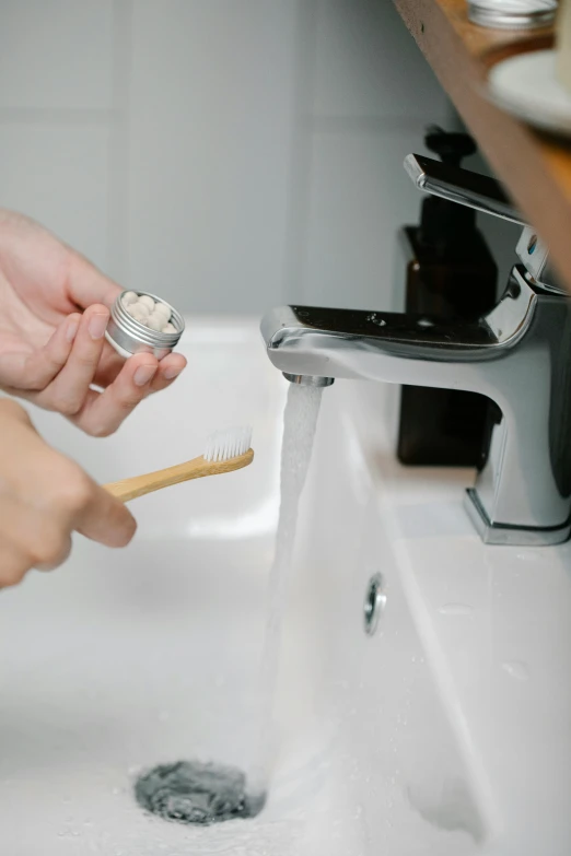 a person using a toothbrush to clean a sink, by Ben Zoeller, made of bamboo, skincare, vanilla, thumbnail