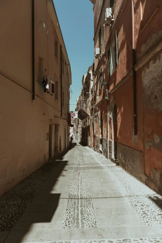 a narrow street in an old european city, a picture, unsplash contest winner, renaissance, clear and sunny, sunfaded, bizzaro, contrasting shadows