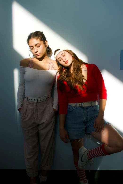 a couple of women standing next to each other, inspired by Nan Goldin, trending on pexels, renaissance, high shadow, teenage, studio lit, promotional image