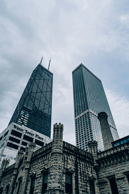 a couple of tall buildings sitting next to each other, a photo, by Robbie Trevino, trending on unsplash, from wheaton illinois, monumental structures, photo taken in 2018, multiple stories