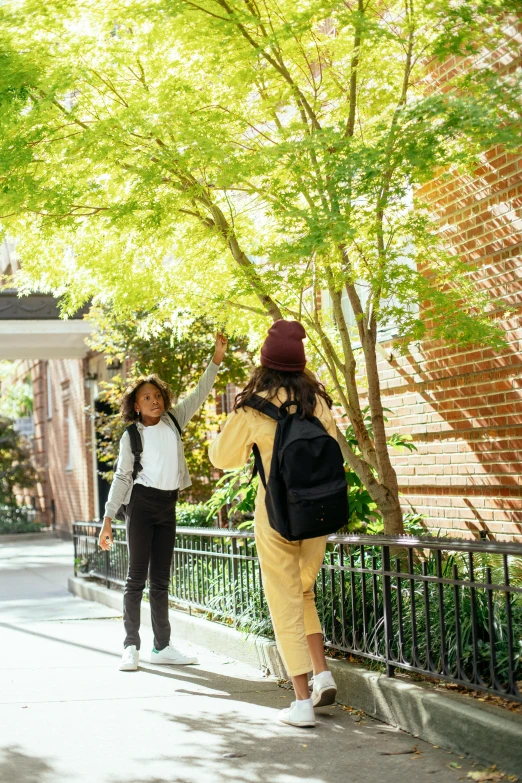 a group of people walking down a sidewalk, a picture, by Washington Allston, unsplash, american barbizon school, leaping from babaob tree, college girls, courtyard walkway, young women