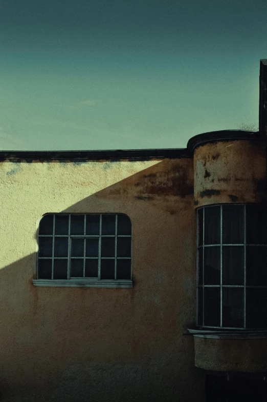 a man riding a skateboard up the side of a building, inspired by Elsa Bleda, unsplash, postminimalism, expired burned film from 1930s, rounded roof, window ( city ), albuquerque