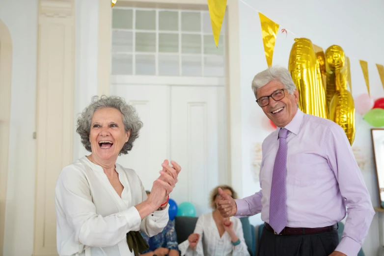 a man and a woman standing next to each other, pexels contest winner, happening, old lady screaming and laughing, at a birthday party, dance scene, 15081959 21121991 01012000 4k