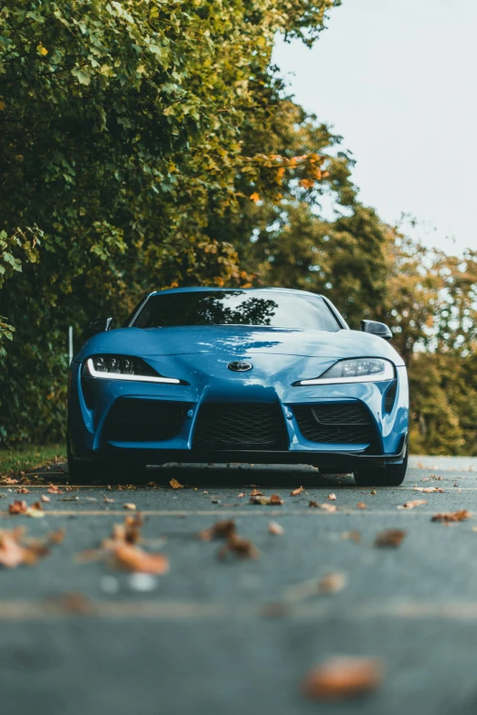 a blue sports car parked on the side of a road, by Adam Marczyński, pexels contest winner, toyota supra, front portrait, instagram post, brown