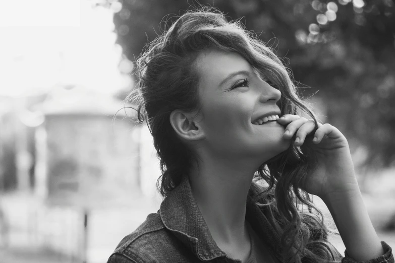 a black and white photo of a woman talking on a cell phone, by Emma Andijewska, with a beautifull smile, windy hair, aleksander rostov, profile image