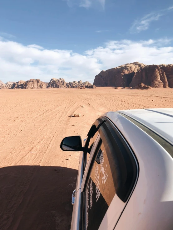 a car that is sitting in the sand, les nabis, top of a canyon, up close, distant photo, 🤠 using a 🖥