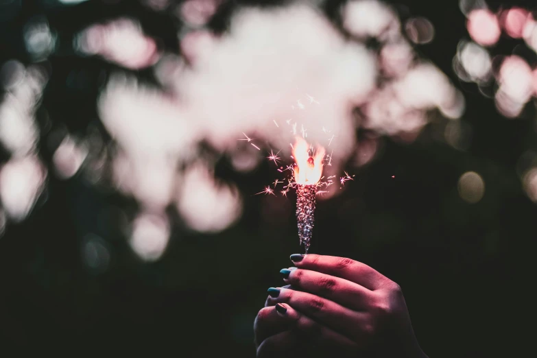 a person holding a sparkler in their hand, pexels contest winner, pink, instagram post, fourth of july, retro stylised