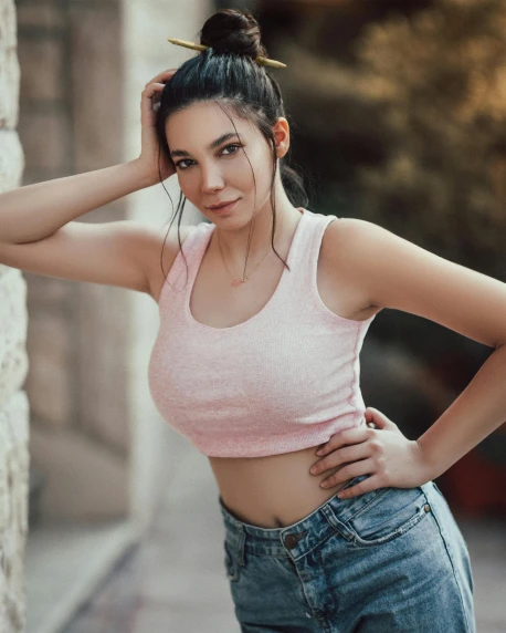 a woman leaning against a wall with her hands on her head, a colorized photo, inspired by Elsa Bleda, trending on pexels, renaissance, wearing a low cut tanktop, pink clothes, beautiful young asian woman, physical : tinyest midriff ever