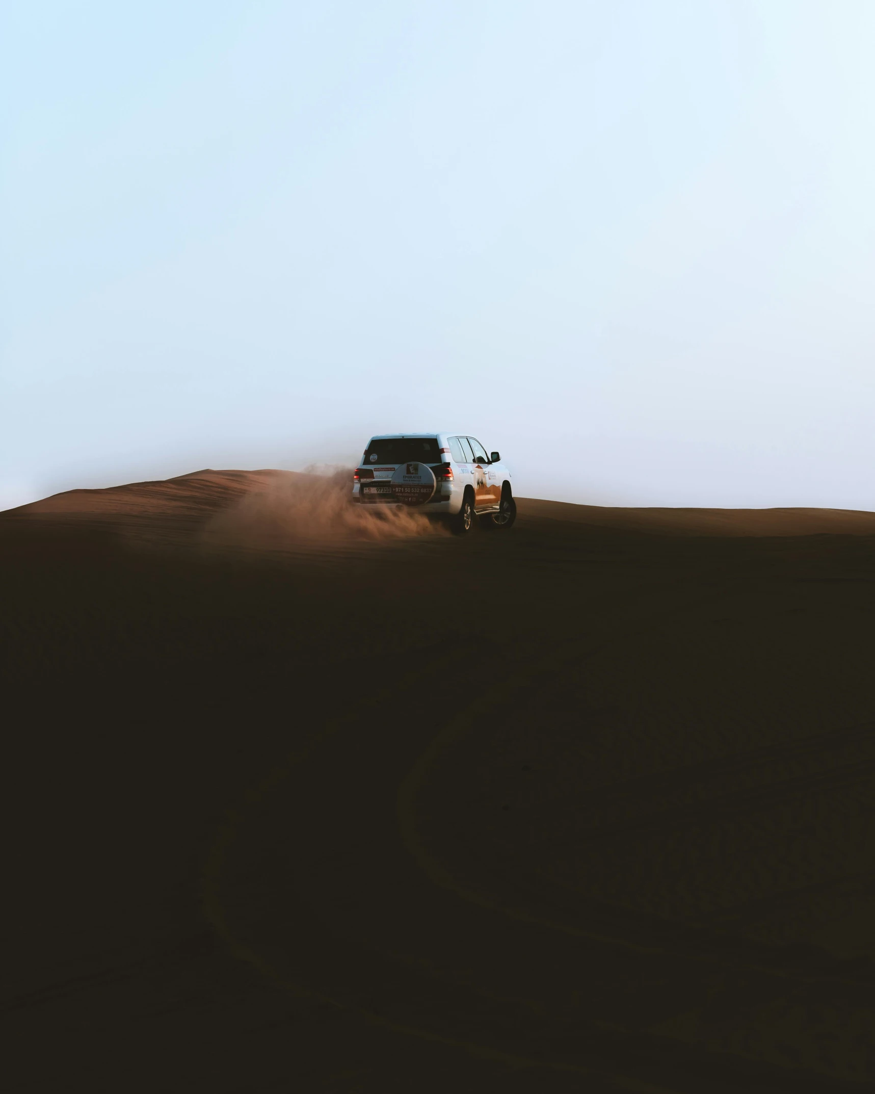 a car driving through the desert on a sunny day, pexels contest winner, minimalism, moonwalker photo, 8k photo, gif, intimidating floating sand