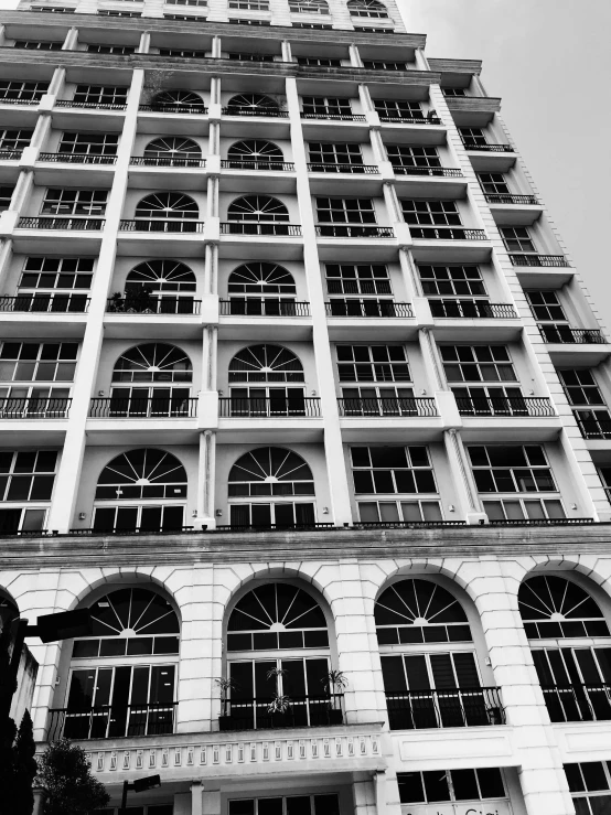 a black and white photo of a tall building, !! low contrast!!, freddy mamani silvestre facade, downtown mexico, square