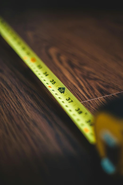 a measuring tape sitting on top of a wooden table, on display, floor, up close, instagram post