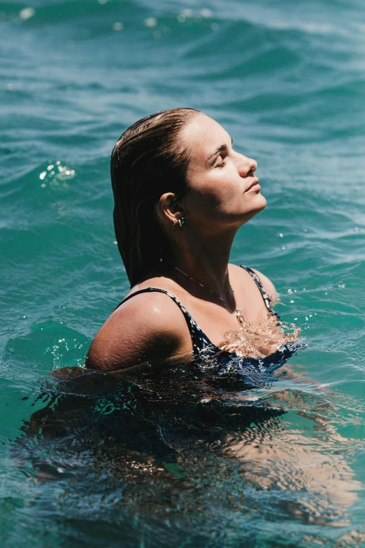 a woman that is in the water with a frisbee, an album cover, unsplash, cameron diaz portrait, profile image, penelope cruz, conde nast traveler photo