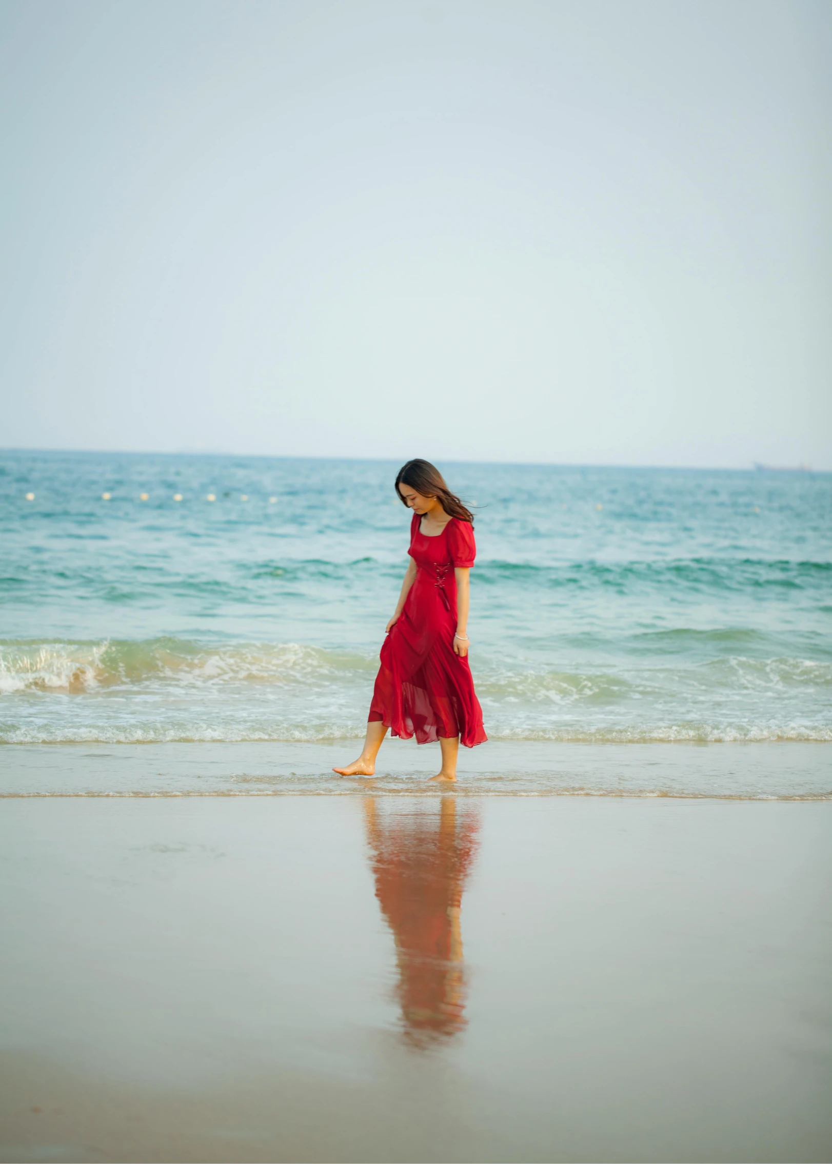 a woman in a red dress walking on the beach, pexels contest winner, bae suzy, wavy, 15081959 21121991 01012000 4k, medium format. soft light