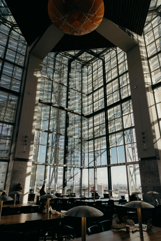 a room filled with lots of tables and chairs, inspired by Richard Wilson, unsplash, light and space, towering high up over your view, lots of glass details, terminal, grand library