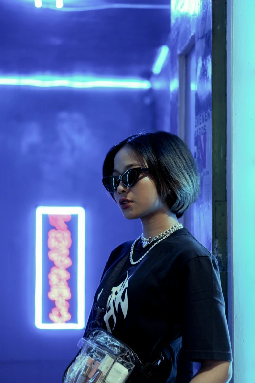 a woman standing in front of a neon sign, an album cover, inspired by Zhu Da, trending on pexels, dark glasses, bob cut, tessa thompson, mall goth