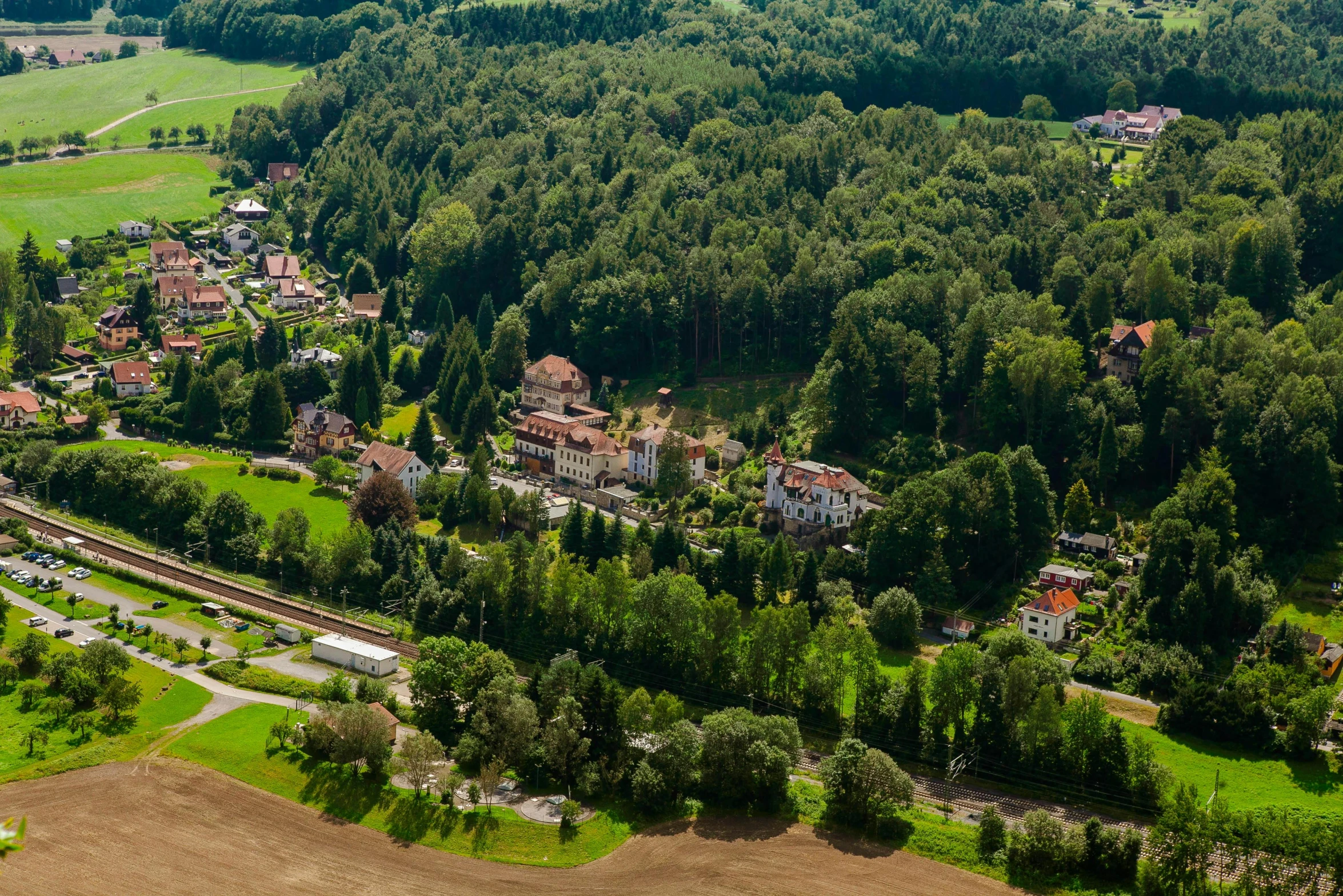 an aerial view of a small town surrounded by trees, a picture, inspired by Otto Meyer-Amden, fan favorite, munkácsy, no cropping, square