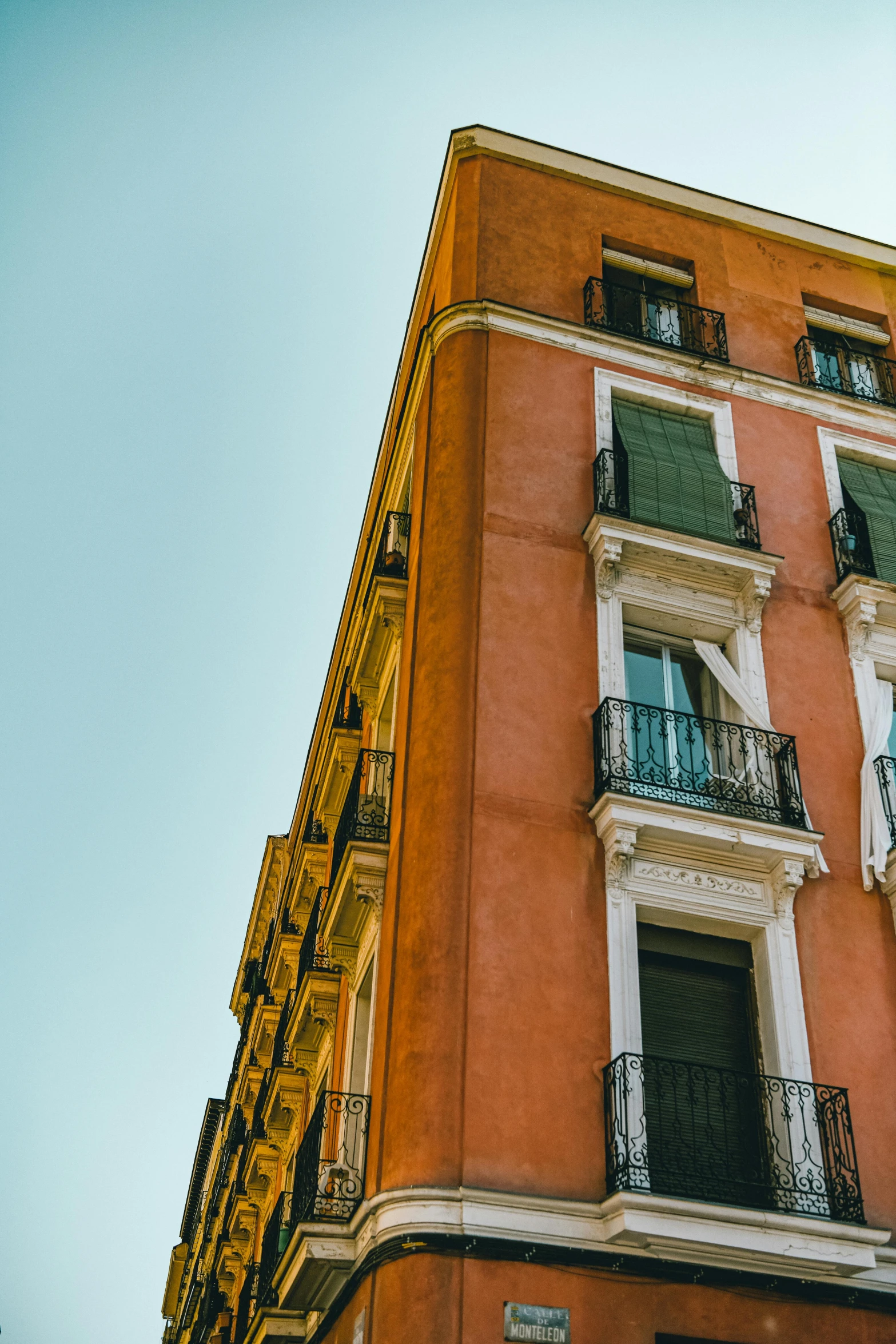 a tall building with lots of windows and balconies, inspired by Ricardo Bofill, pexels contest winner, neoclassicism, madrid, french village exterior, crisp colors, square