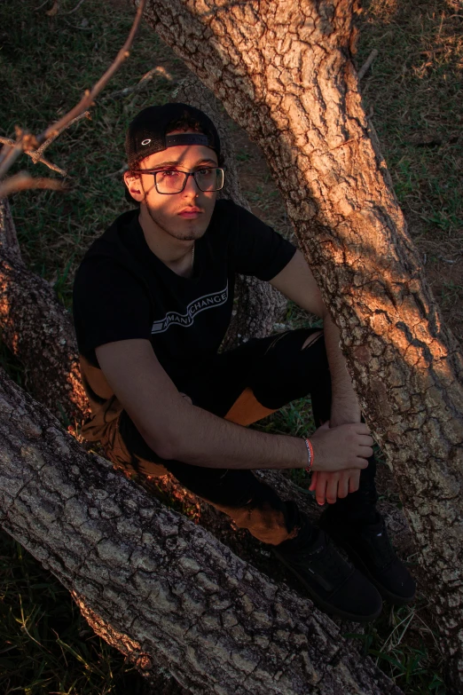 a man that is sitting in a tree, trending on reddit, realism, discord profile picture, high quality photo, androgynous male, outdoor photo