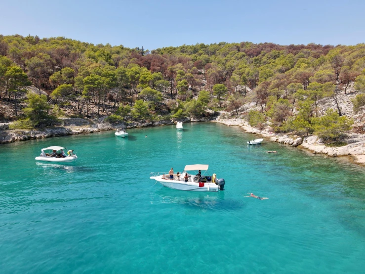 a group of boats floating on top of a body of water, les nabis, crystal clear blue water, al fresco, meni chatzipanagiotou, archipelago