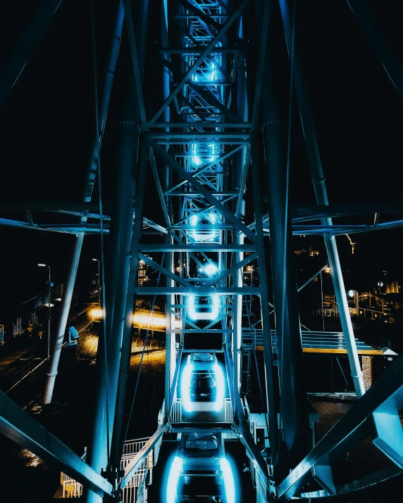 a large ferris wheel lit up at night, pexels contest winner, interactive art, on a bridge, black and blue, thumbnail, multiple stories