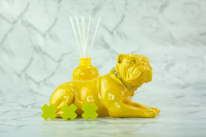 a yellow dog figurine sitting on top of a table, an art deco sculpture, inspired by Fernando Botero, process art, glass and gold pipes, mono-yellow, yorkshire, made of bamboo