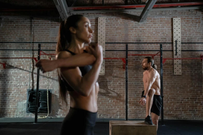 a man and a woman in a crossfit gym, pexels contest winner, back and standing, profile image, background image, game ready