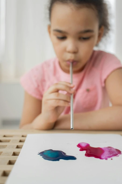 a little girl is painting on a piece of paper, inspired by Helen Frankenthaler, pexels contest winner, made of lollypops, alcohol ink art, plasticine, lips