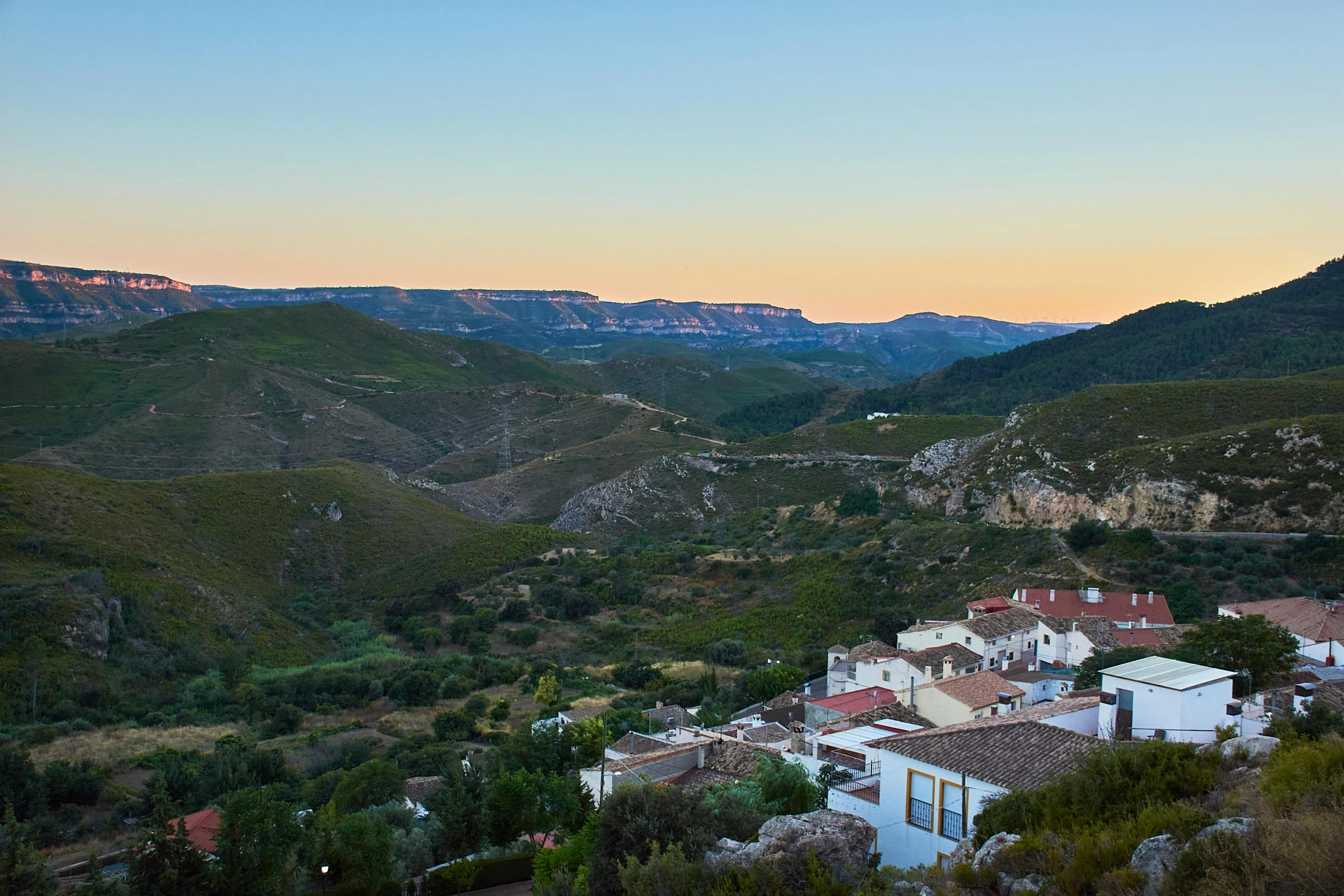 a view of a town from the top of a hill, by Julian Allen, pexels contest winner, les nabis, sunset in a valley, square, white, mead