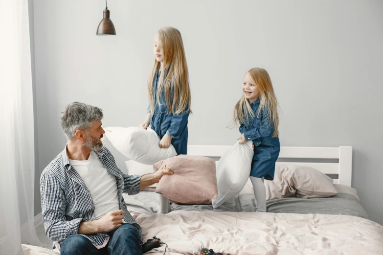 a man sitting on top of a bed next to a little girl, throw pillows, 15081959 21121991 01012000 4k, full body image, grey