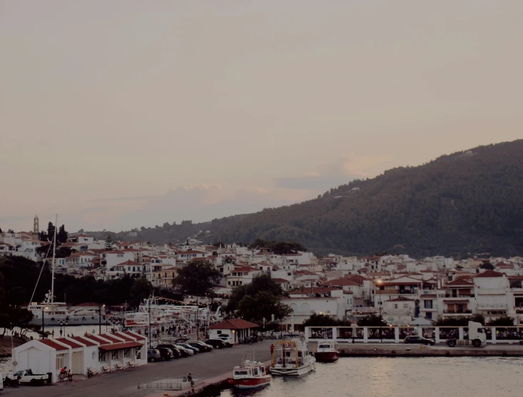 a large body of water filled with lots of boats, by Alexis Grimou, pexels contest winner, white houses, soft glow, greek nose, profile image