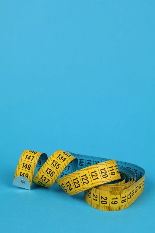 a measuring tape on a blue background, by Carey Morris, happening, half - body composition, thumbnail, stacked image, iso 125