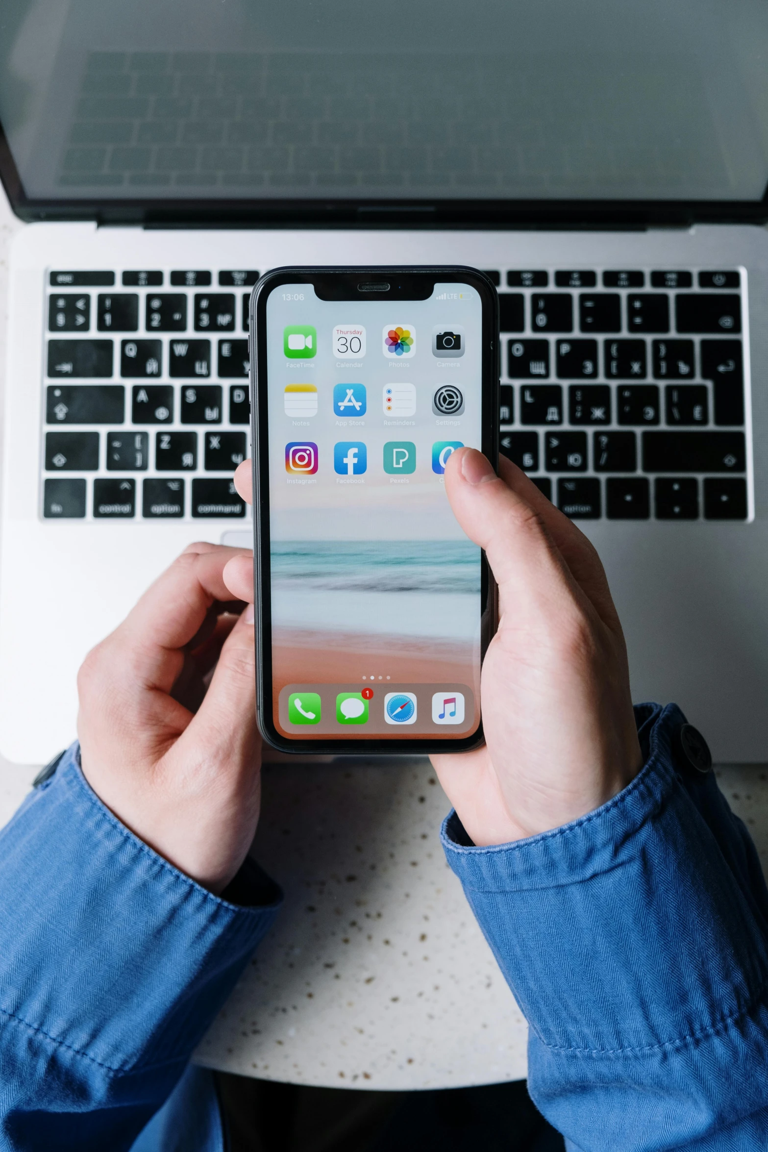 a person holding an iphone in front of a laptop, by Carey Morris, trending on unsplash, square, iphone 12, 2 5 6 x 2 5 6 pixels, ios icon