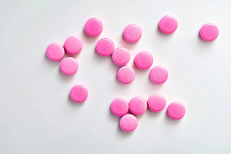 a pile of pink pills on a white surface, by Nicolette Macnamara, visual art, macaron, magenta, medium, juice